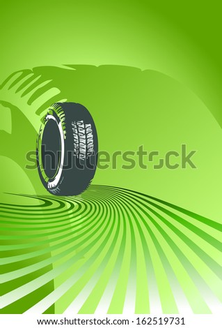 Brand new tire on a green background