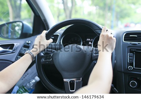 lady is learning drive a car catch steering wheel