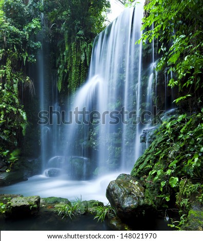 Castle ruins surrounded by rainforest gardens right beside a stunning waterfall Castle ruins surrounded by rainforest gardens right beside a stunning waterfall