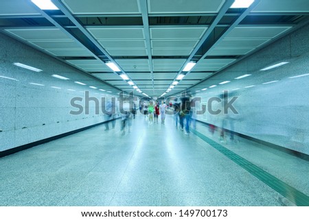 business people walking in metro station tunnel for transfer