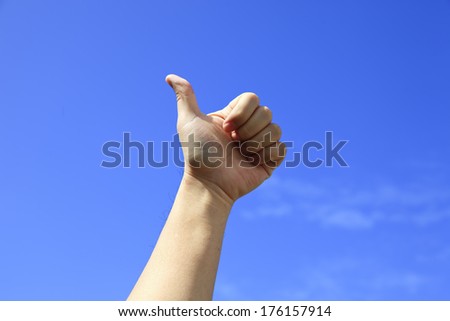 good and number one gesture in blue sky background