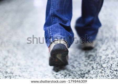 walking and step forward with outdoor shoes and jeans