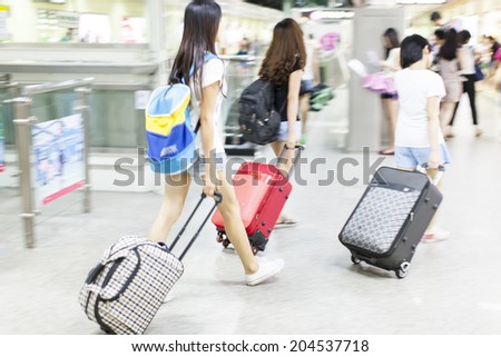 people walking with baggage at metro station