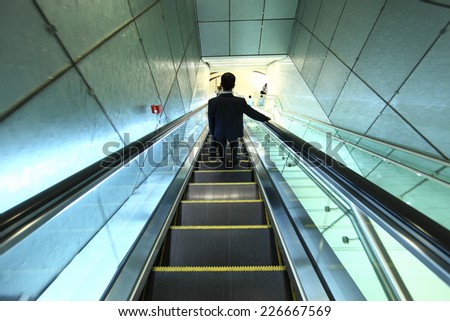 business people on escalator at metro station in United Emirate