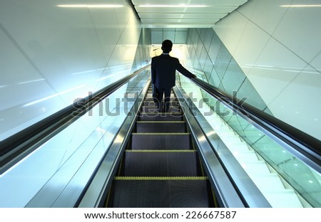 business people on escalator at metro station in United Emirate