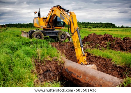 An excavator on the gas pipeline performs excavation work.