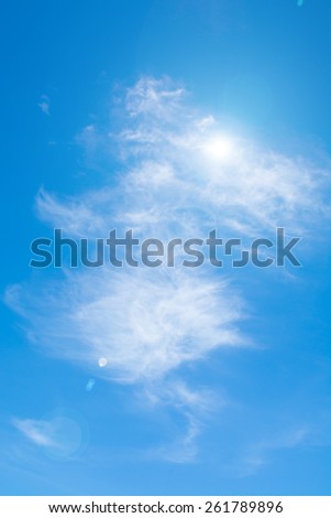 Sun on blue sky with lens flare