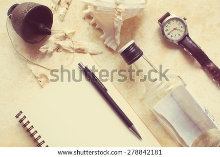 Vintage image of notebook, pen, watch and little bell on canvas