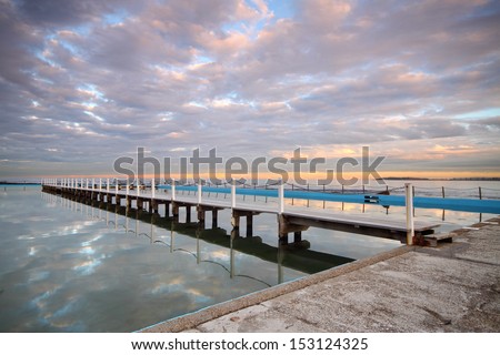 Early morning tidal pool with beautiful cloud reflections
