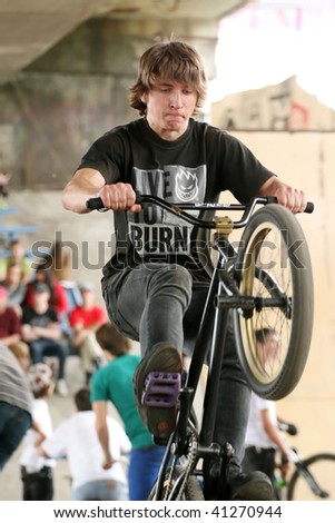 UKRAINE, KIEV - MAY 30: Dmitriy Sergeyev making jumps and tricks, at the extreme bicycle trial competition \