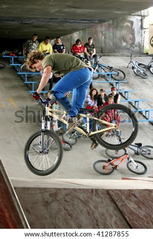 UKRAINE, KIEV - MAY 30: Ivan Drozd making jumps and tricks, at the extreme bicycle trial competition \