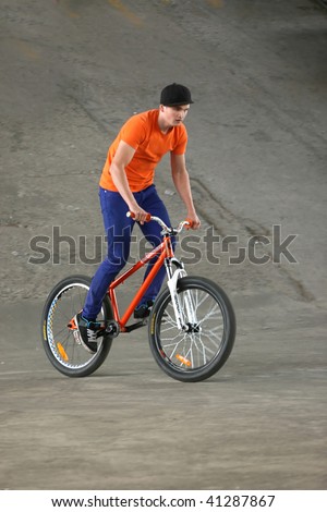 UKRAINE, KIEV - MAY 30: Alexander Ivanov making jumps and tricks, at the extreme bicycle trial competition \