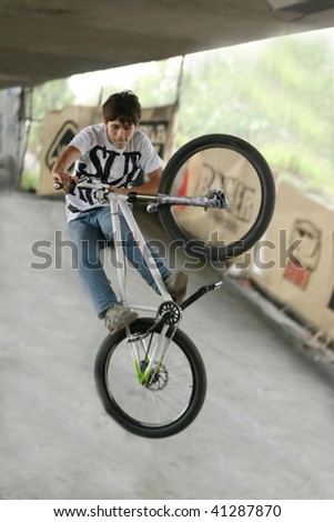 UKRAINE, KIEV - MAY 30: Alexander Pohilenko making jumps and tricks, at the extreme bicycle trial competition \