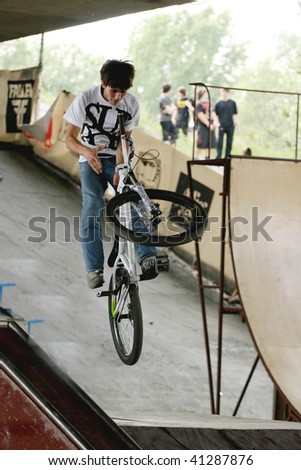 UKRAINE, KIEV - MAY 30: Alexander Pohilenko making jumps and tricks, at the extreme bicycle trial competition \