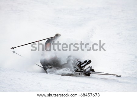 Man riding on skis fall down, he could break something.