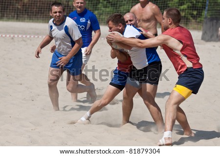 XII RUGBY BEACH TOURNAMENT, UKRAINE, KIEV - JUNE 18 : Rugby players in action at a XII Ukrainian Rugby Beach Tournament, Antares(in red) vs. Spartak(in blue),  on June 18, 2011 in Kiev, Ukraine.