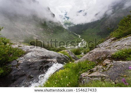 Magic mountain landscape with waterfall and mist, Georgia.