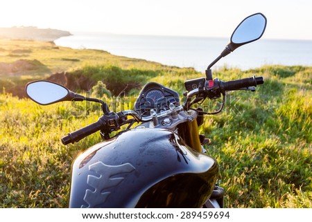 Motorcycle above the sea landscape, travel background.