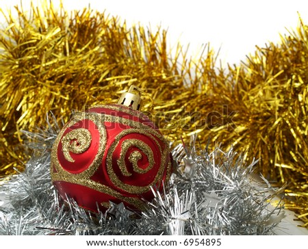 Christmas red ornaments and gold tinsel on white background
