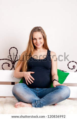 The beautiful pregnant woman touches a stomach and feels movements of the kid