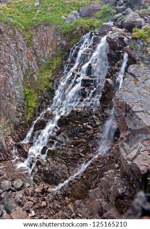 Beautiful waterfall on the coast of Barents Sea