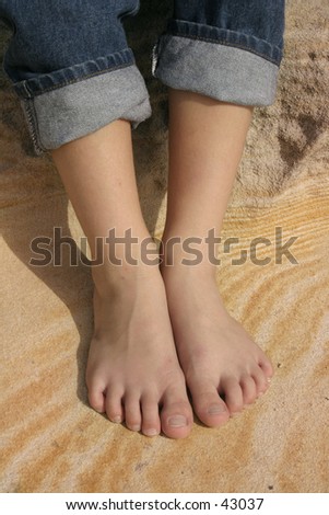 Childs feet on a pattern of sandstone.