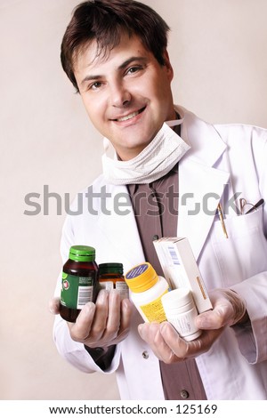 Doctor holding a variety of medicines and supplements