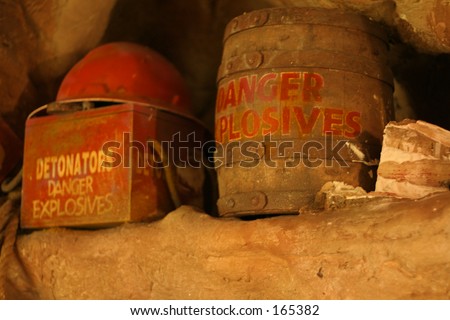 Old grungy explosives and mining helmut in a cave\
\
(shallow dof)