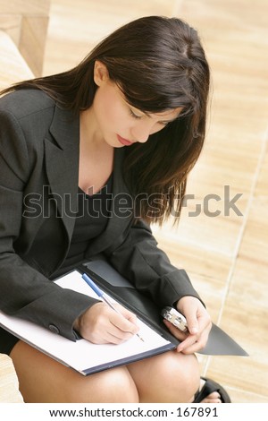 Woman studying, writing, notetaking, preparation