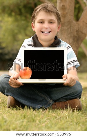 A child holding a laptop with a blank screen ready for your logo or message.