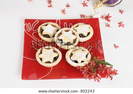 Christmas tarts on a decorative plate with ornamental Australian Christmas bush flowers.