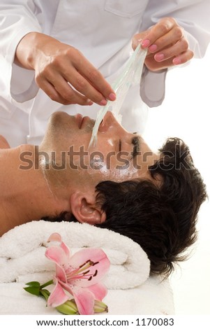 Facial Peel - A beautician performs a facial peel on a male client.