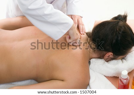 A woman receives a deep tissue massage with kneading.  Kneading is a massage technique in the category of petrissage movements