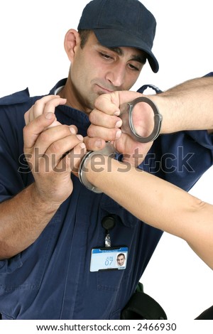 A criminal is apprehended and handcuffed Please note Photo