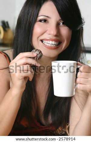 A woman enjoys coffee and chocolate