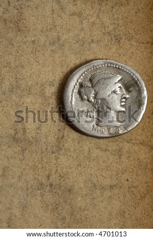 Silver AR denarius from Roman Republic dated 89bc on aged paper.  Front side depicting female draped hair taken in chignon.  Behind the nape of the neck, ROMA, Under the neck, M.Cato.
