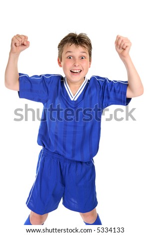 An elated boy celebrates with two fists in the air