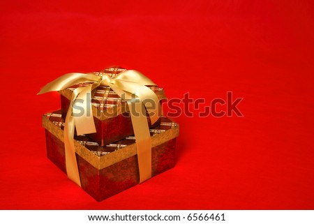 Gift boxes tied up with gold satin ribbon for Christmas, a birthday or other special occasion