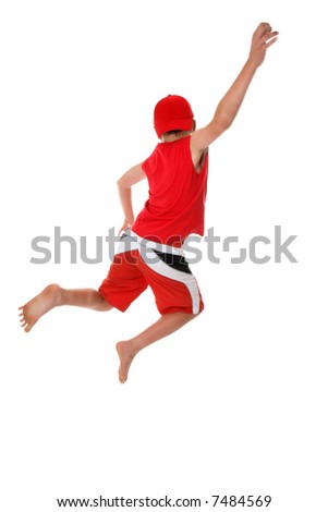 Boy jumps hand raised  in the air.  Jump for joy, leap of faith, etc, fitness, fun or concept.  There is a little bit of  motion in the arm and feet at full size..