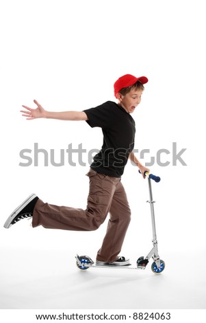An active happy child riding and playing on a scooter on a white background