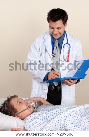 Caring cheerful doctor assesses a young patient\'s recovery.  No release required for ID badge and photo