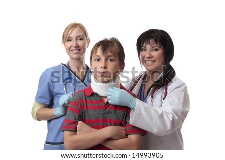 Smiling medical doctor and nurse and child fitted with a cervical collar.