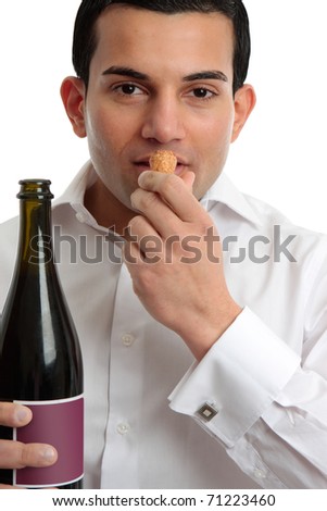 A man or wine steward sniffing the cork from wine.  White background.