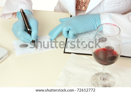 A crime scene forensic scientist obtains fingerprints from a glass using latent powder and tape and then writes down details.  Details are fictitious.