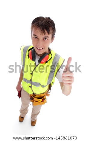 Smiling apprentice builder thumbs up.  White background.