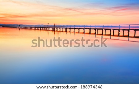 Magnificent colours in the sky, pink towards the north and red towards the south, at idyllic Long Jetty Central Coast, Australia
