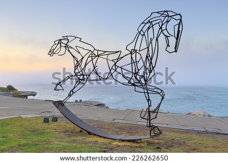 BONDI, AUSTRALIA -  OCTOBER 25, 2014; Sculpture by the Sea annual free public  event 2014.  A sea fog rolls in behind the sculpture titled Which Way Forwards by  Harrie Fasher, NSW.