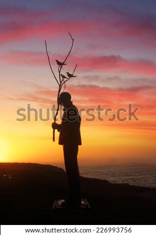 BONDI, AUSTRALIA - OCTOBER 23, 2014; Sculpture by the Sea Annual free public event 2014.  Exhibit titled Man playing with Birds  by artist Wang Shugang, China,  Materials, stainless steel, titanium,