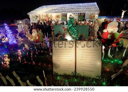 QUAKERS HILL, AUSTRALIA - DECEMBER 24 2014; Crowds o people visit and enjoy this decorated home for Christmas, with led lights, christmas trees, santa, nativity scens, angels and more