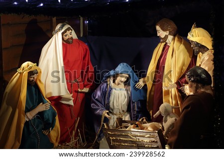 QUAKERS HILL, AUSTRALIA - DECEMBER 24 2014;  Nativity scene Mary, birth of Jesus in manger with Wise Men in stable  worship gifts.